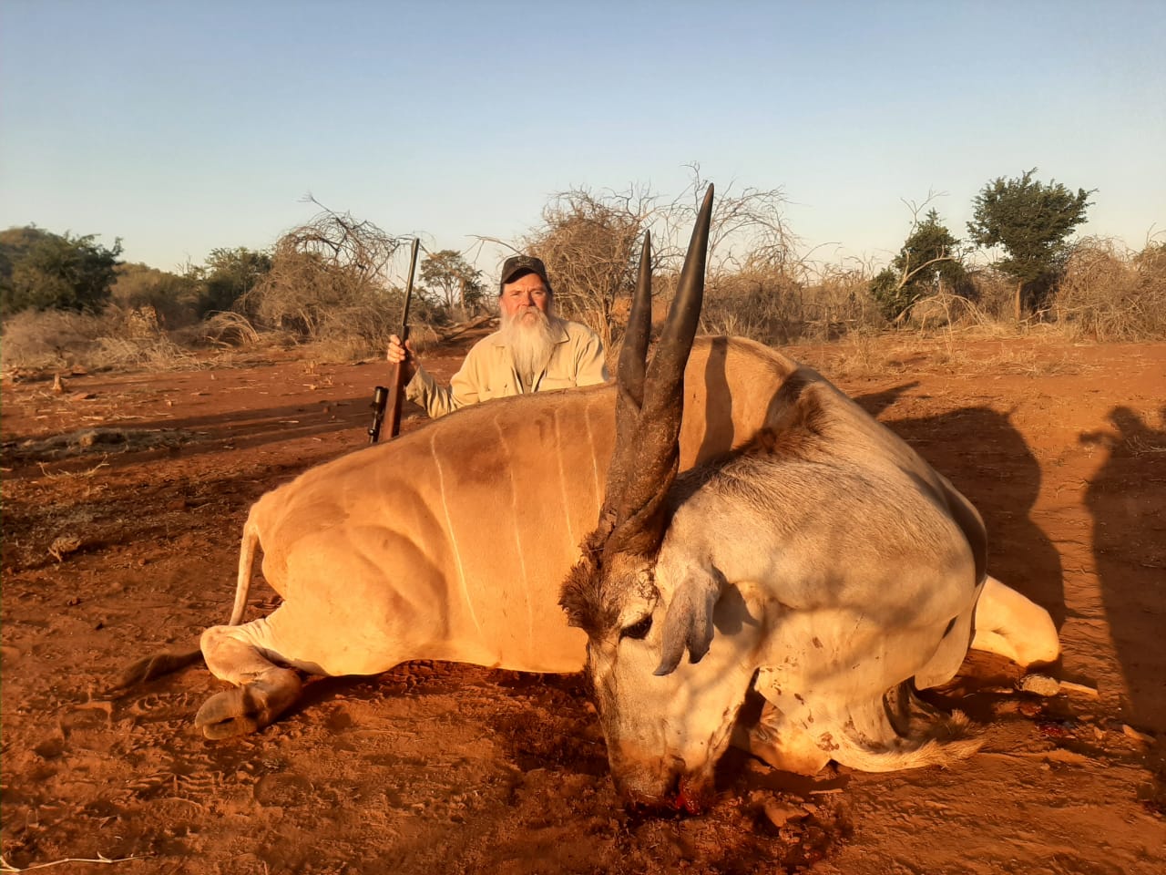 A client next to their hunting trophy