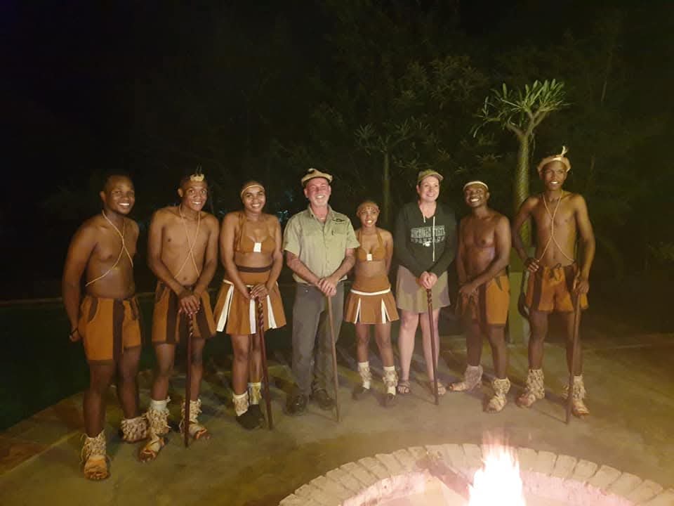 A client with a group of indigenous people smiling