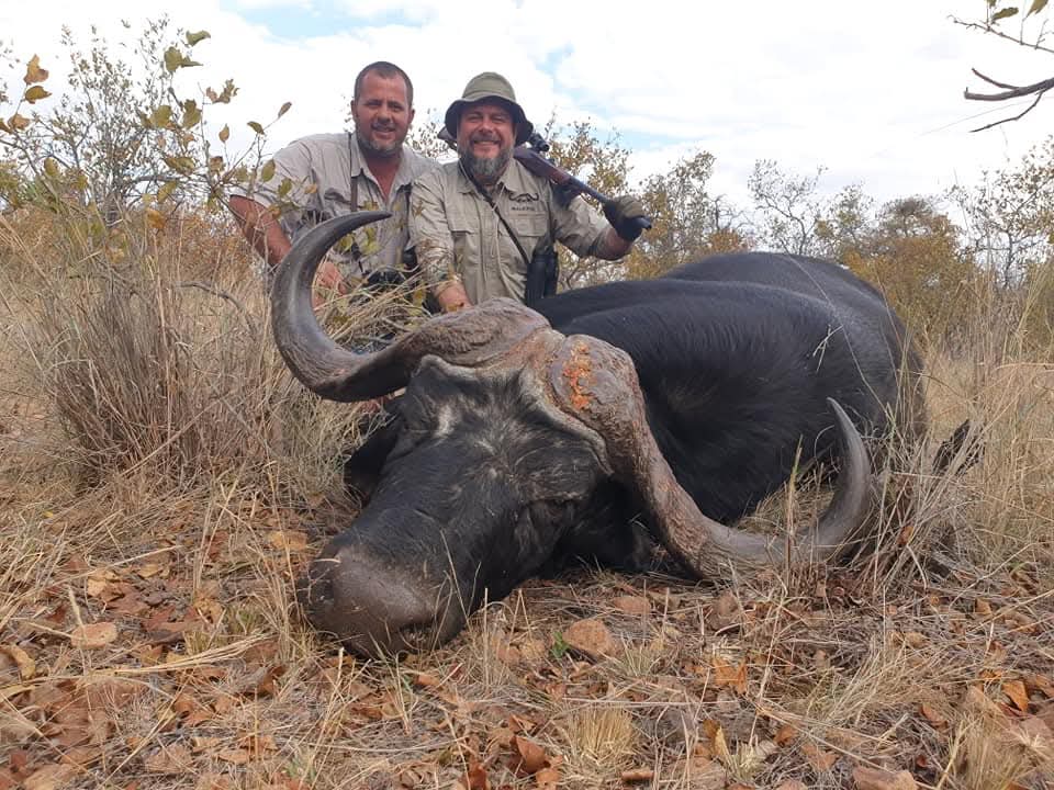 A client next to their hunting trophy
